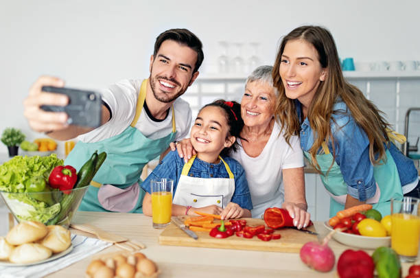 istock Happy family is taking selfie/making video call together in a kitchen 1457977397