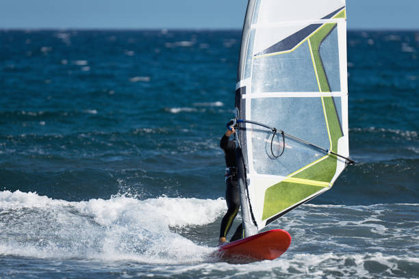 istock Windsurfer surfing the wind on waves in ocean sea 1457978761