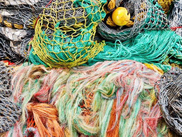 Fish Nets and Floats Fish nets and floats are heaped together for storage at Fisherman's Terminal in the Ballard area of Seattle. ballard-seattle stock pictures, royalty-free photos & images