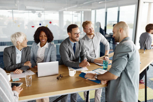 istock Group of happy entrepreneurs working in a modern office. 1457981523