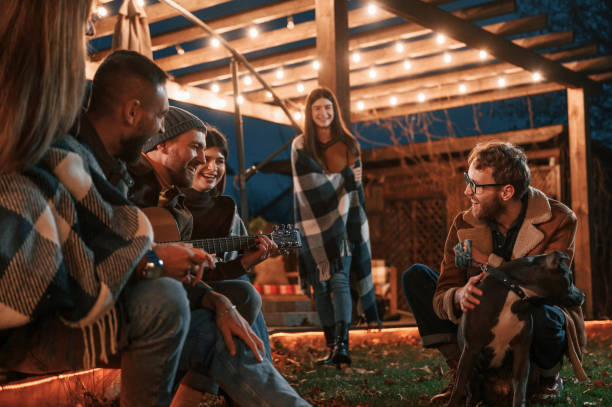 istock Evening time. Group of people is spending time together on the backyard 1457984064