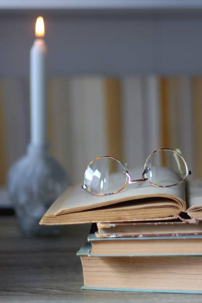 istock Candle, Books, Glasses and Bookshelf 1457985441