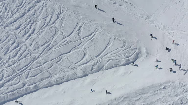 People tourists riding skiing snowboarding on snow slope turn track ski resort outdoor extreme