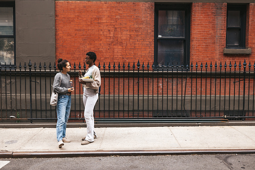 Friends talking on sidewalk in the West Village, NY