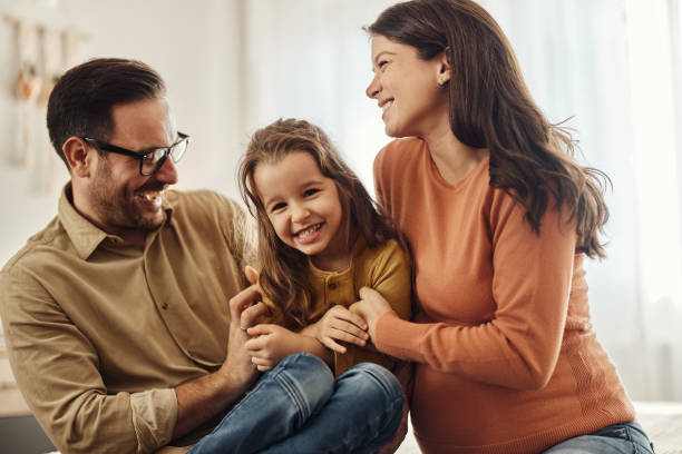 istock Cheerful expecting family having fun while playing in bedroom. 1457991334