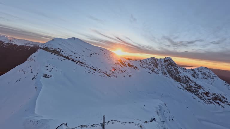 Winter mountain valley snow cliff altitude environment sun sky horizon sunset sunrise aerial view