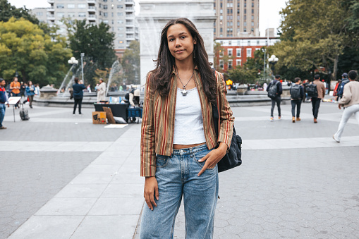 Multiracial young student standing for a street portrait in Washington Square NY.