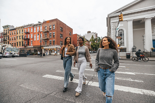 Multi ethnic young students walking in New York City.