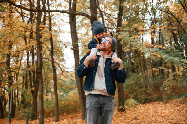 istock Having a walk in forest. Father and young son is together outdoors at daytime 1457993255