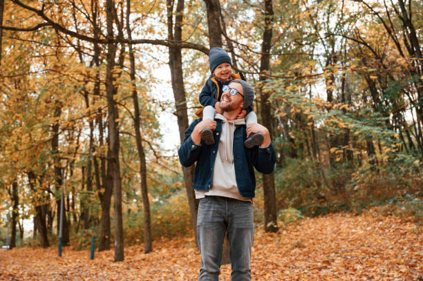 istock Having a walk in forest. Father and young son is together outdoors at daytime 1457993276