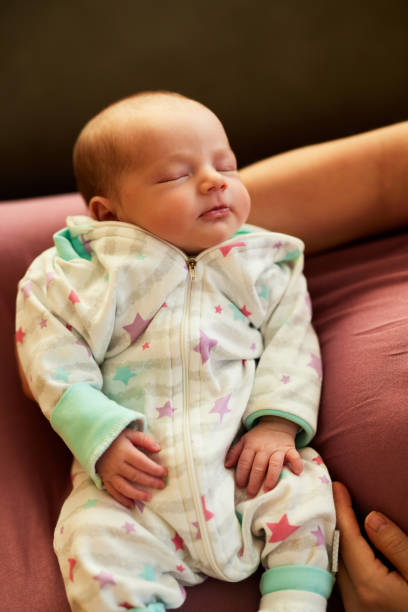 istock Newborn baby girl sleeping. 1457993277
