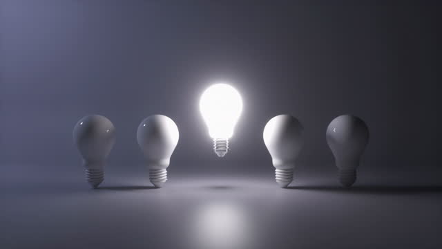 Creative new idea concept with light bulbs. One light bulb standing out from others bulbs floating on dark background. Business, success, think positive, inspiration, solution symbol. 3D Animation.