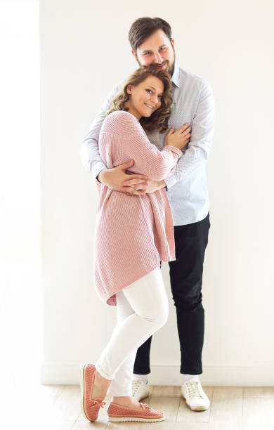 istock Tender couple hugging on white background 1457994606