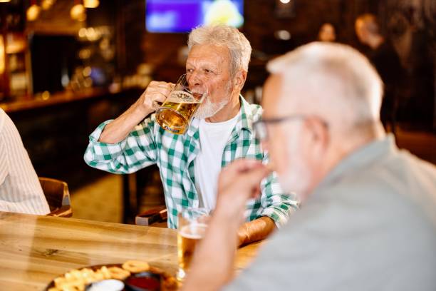 istock Senior Men in Pub drinking beer 1457997377