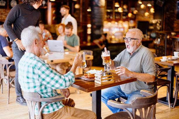 istock Senior male friends in the pub 1457997548