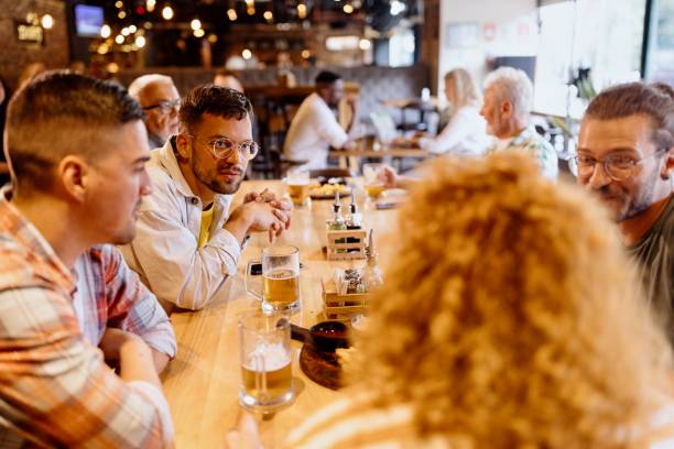 istock Friends drinking beer in the pub 1457998213