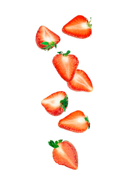 Falling of strawberry slices isolated on white