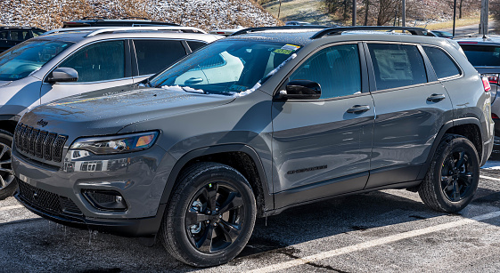 Monroeville, Pennsylvania, USA January 15, 2023 A new, gray Jeep Cherokee SUV for sale at a dealership on a sunny winter day