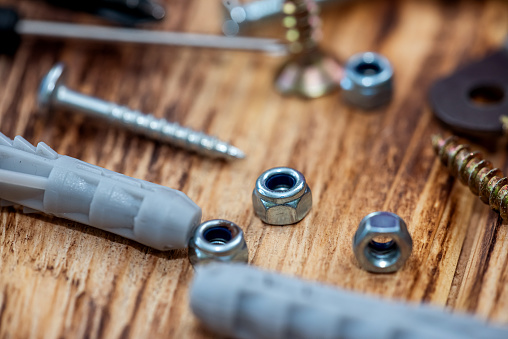 Enlarged view of various screws from above. Mixed screws and nails. Industrial background. Home improvement. bolts and nuts.