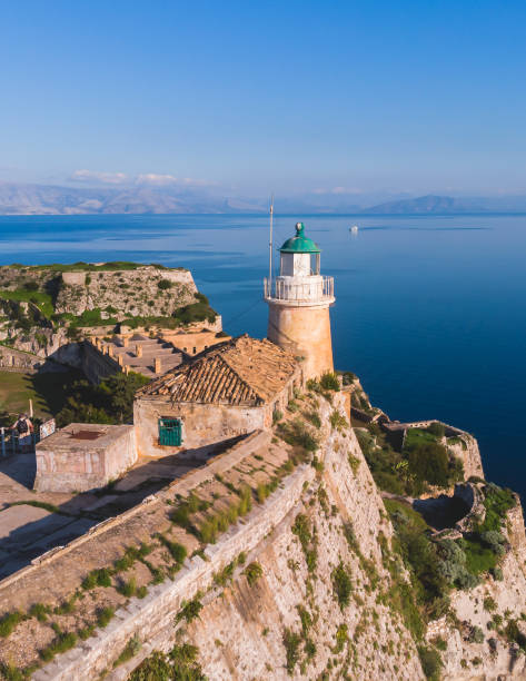 Aerial panoramic drone view of Old Venetian Fortress of Corfu, Palaio Frourio, Kerkyra old town, Greece, Ionian sea islands, with the lighthouse, church and scenery beyond the city in summer sunny day vista aérea panorámica de drones de la antigua fortaleza veneciana de corfú, palaio frourio, el casco antiguo de kerkyra, grecia, las islas del mar jónico, con el faro, la iglesia y el paisaje más allá de la ciudad en un día soleado de verano