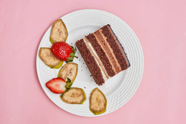 istock a piece of cake on a white plate with fruit 1458001119