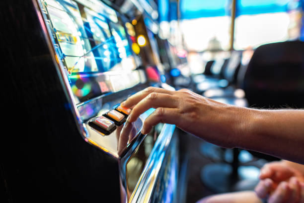 Gambler Pressing Slot Machine Button in the Casino stock photo