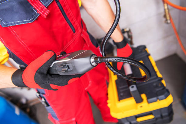 istock Professional Plumber Checking Water Heater with Portable Gas Leakage Detector 1458002521
