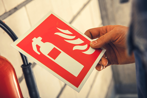 Closeup of Fire Safety Label Illustrating Extinguisher Sign for Equipment Placement Indication.