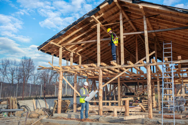 istock Builders workig on wooden house. 1458002629