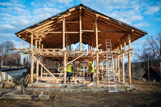 Hard working constuction workers working on the process of building a wooden home.