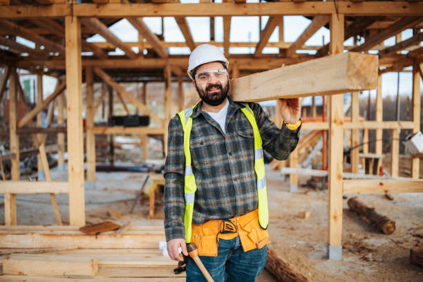 Portrait of a smiling construction worker at construction site.