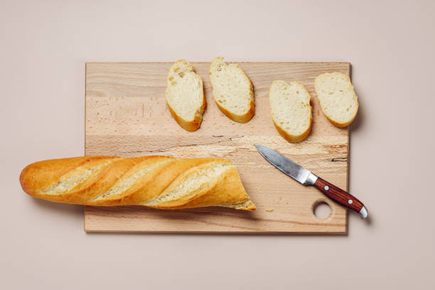 istock Sliced baguette on a cutting board. 1458003124