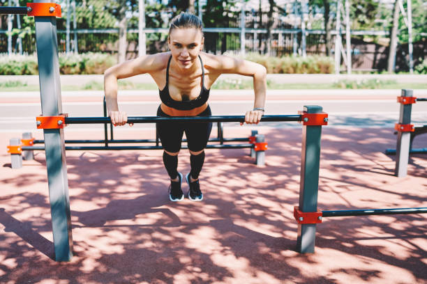 istock Content sporty female doing push up exercise in stadium 1458003489