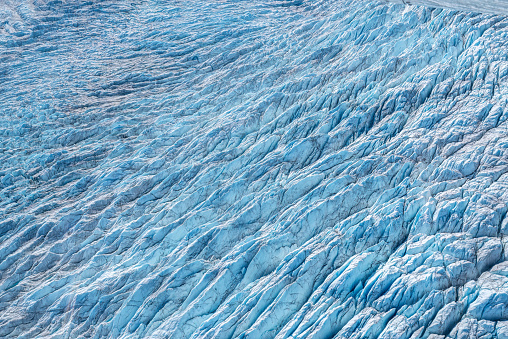 Aerial view of textures, cracks, and small lakes in the ice cap surface near Russell Glacier, Kangerlussuaq, Greenland