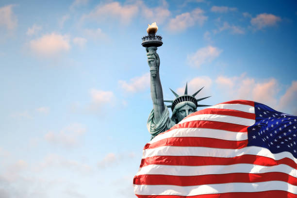 istock Statue of Liberty and American flag 1458004910