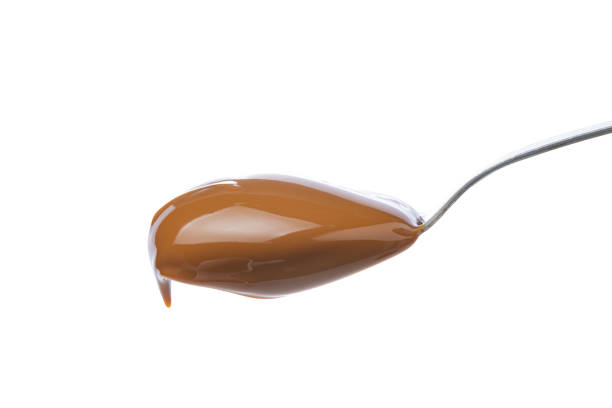 istock Spoon with dulce de leche, traditional sweet from Argentina isolated on white background. 1458010694
