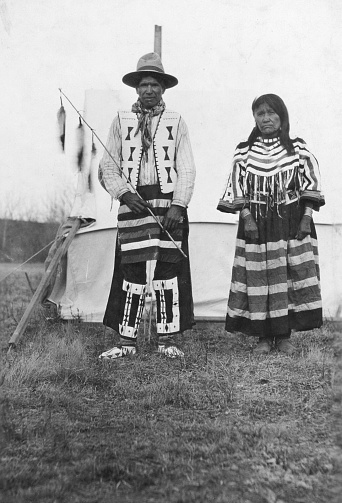 Calgary, Alberta, Canada - 1913. Tsuutʼina couple wearing traditional clothing in Calgary, Alberta, Canada.