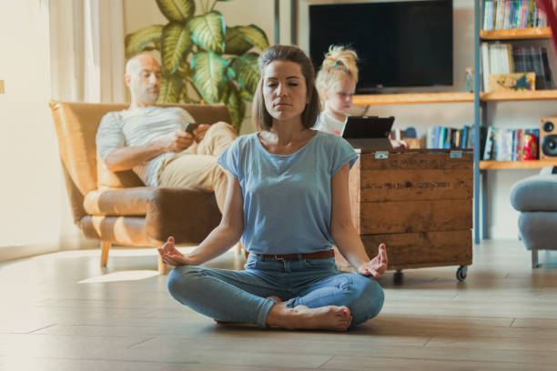 istock Mother seeks relaxation while family plays 1458012542
