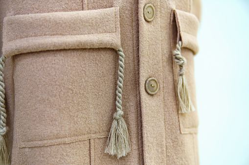 Beige women's coat pocket with rope square form