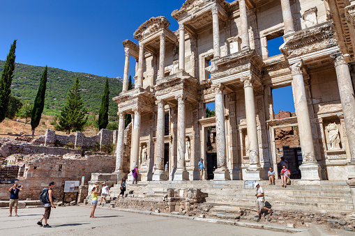 View of a people walking in front of the Library of Celsus. \n Ephesus ancient city, Turkey.