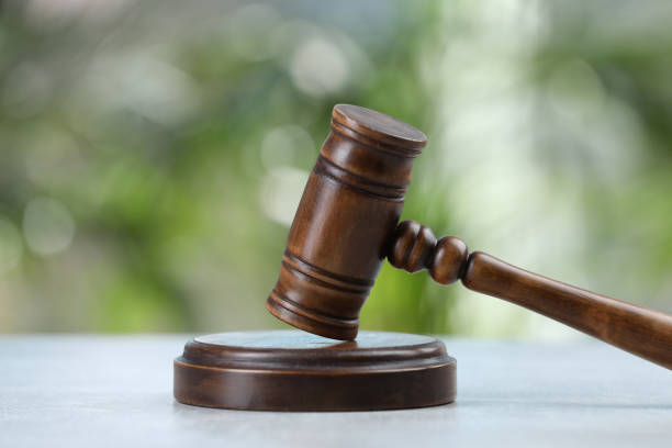 istock Wooden gavel on grey table against blurred background 1458014663