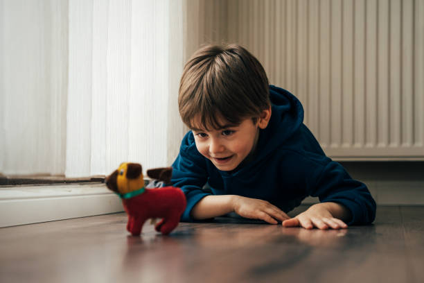 Little boy playing with his toy dog
