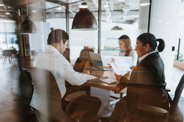 istock Business meeting seen from behind window glass 1458023390
