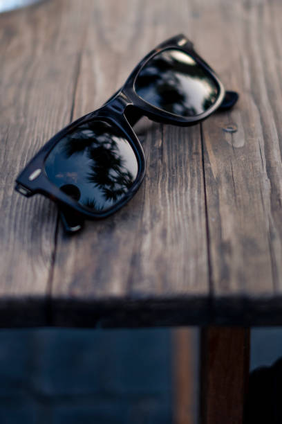 istock Old wooden board with sunglasses on it 1458025775