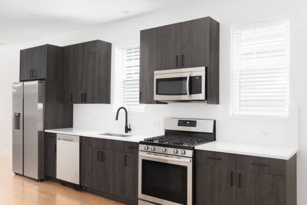 istock A kitchen with dark cabinets and stainless steel appliances. 1458026608