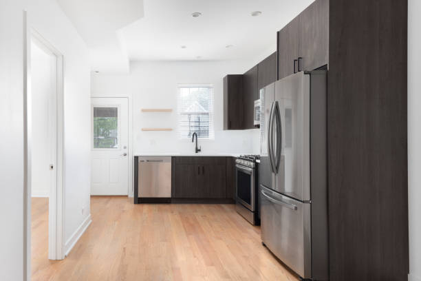 istock A modern, dark wood kitchen with stainless steel appliances. 1458026613