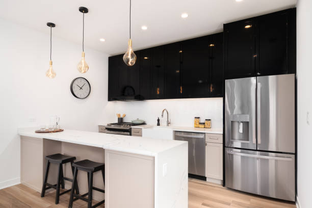 istock A kitchen with reflective black and brown cabinets and a marble countertop. 1458026617