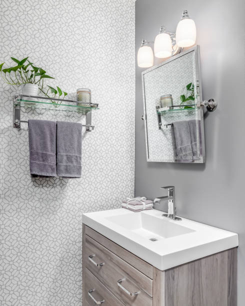 istock A small bathroom with a wood cabinet and a wallpaper wall. 1458026806