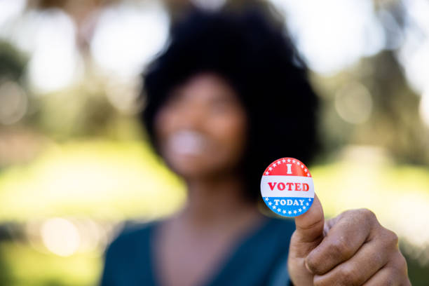 Beautiful young black woman with an I Voted Sticker stock photo