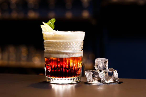 istock On a bar counter and a dark background. Alcoholic cocktail with ice. 1458028700